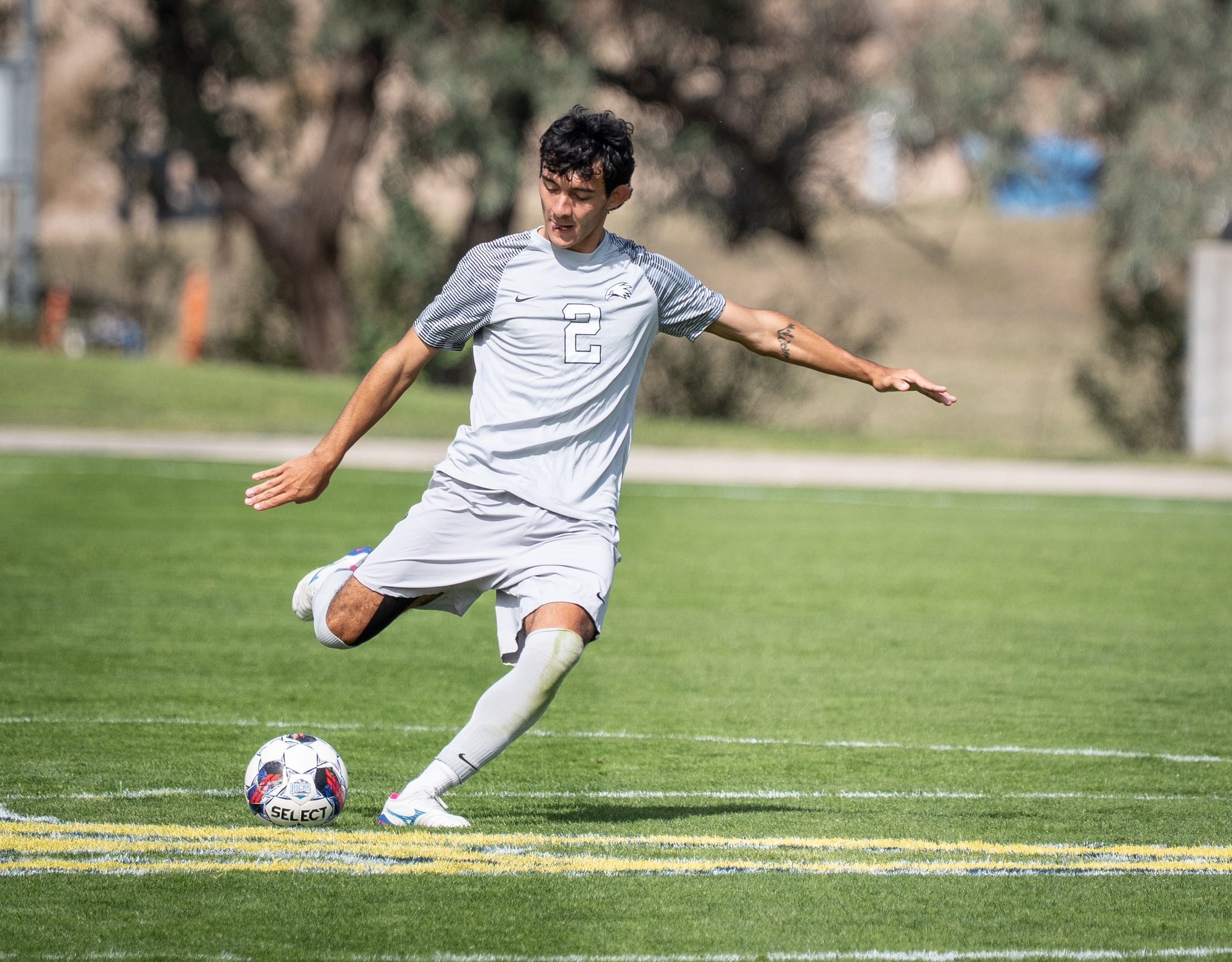 LCCC Men's Soccer Player striking a soccer ball. 