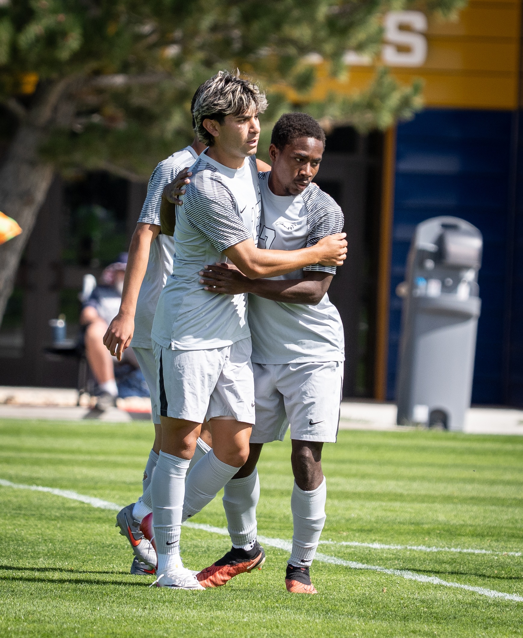Two LCCC Men's Soccer players hugging after a goal scored. 